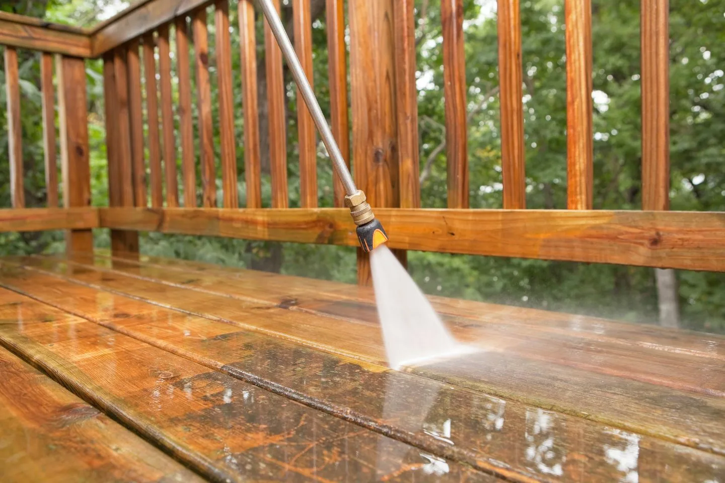 A pressure washer efficiently cleans the wooden deck, effortlessly removing dirt and grime with precision.